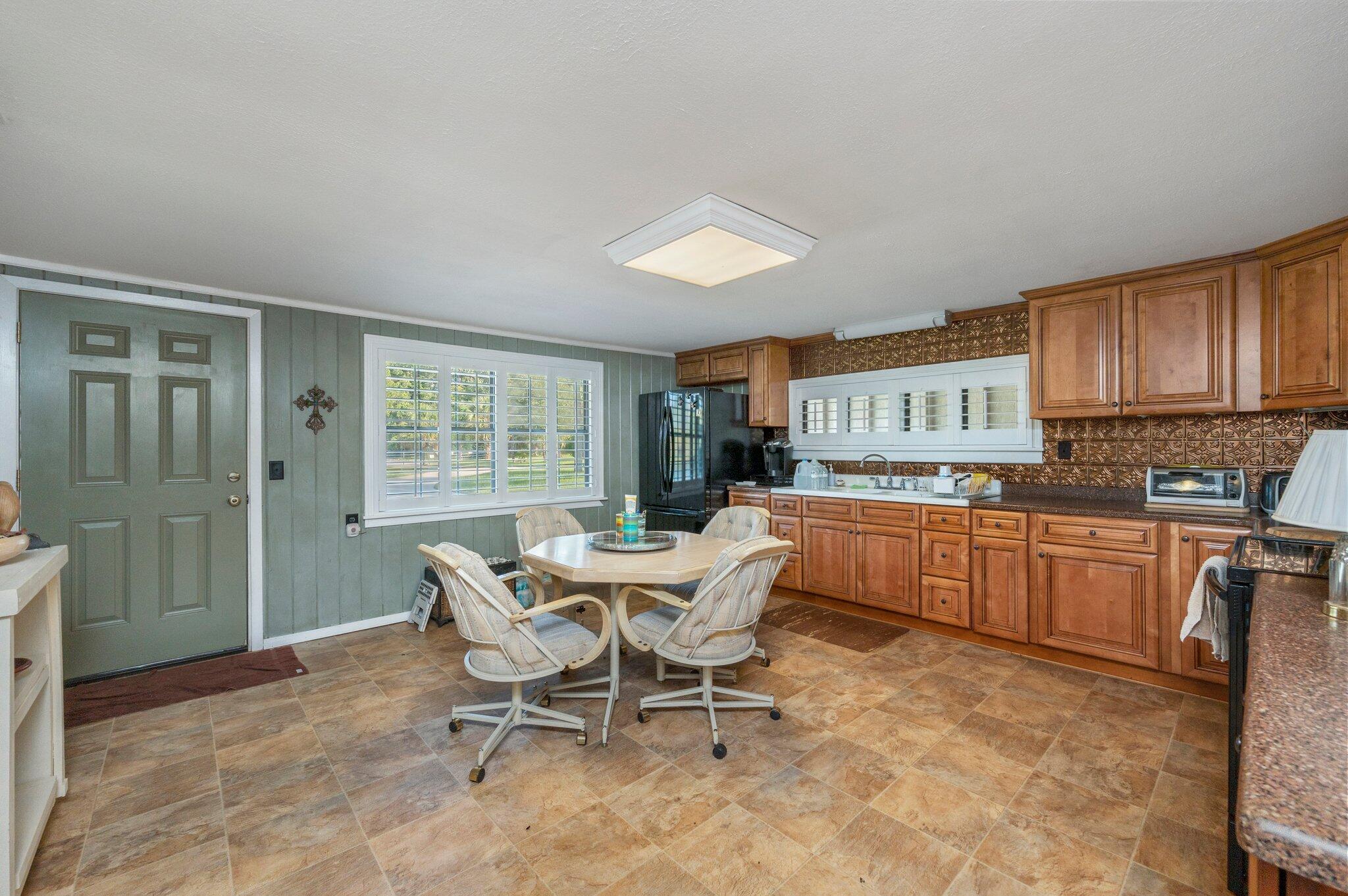 7068 Old River Road Baker, FL 32531 - Photo 14 of 42 a kitchen with granite countertop a sink cabinets and window
