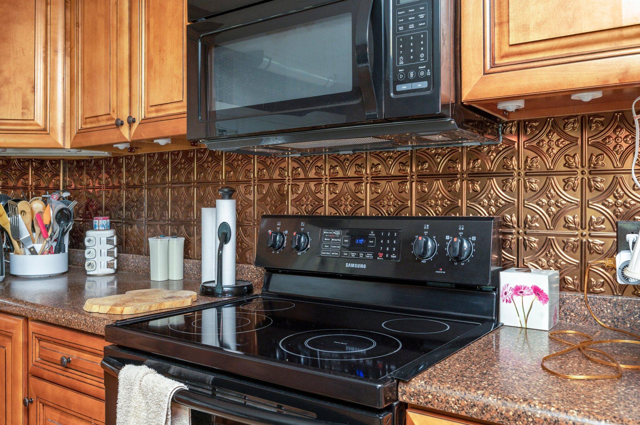 7068 Old River Road Baker, FL 32531 - Photo 15 of 42 a kitchen with a stove a sink and a microwave