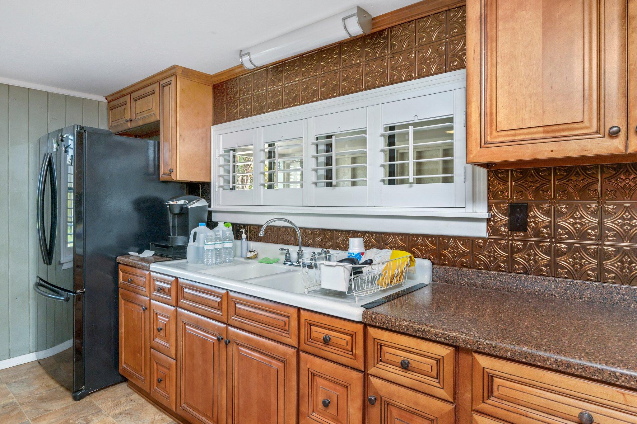 7068 Old River Road Baker, FL 32531 - Photo 17 of 42 a kitchen with stainless steel appliances granite countertop a sink and refrigerator
