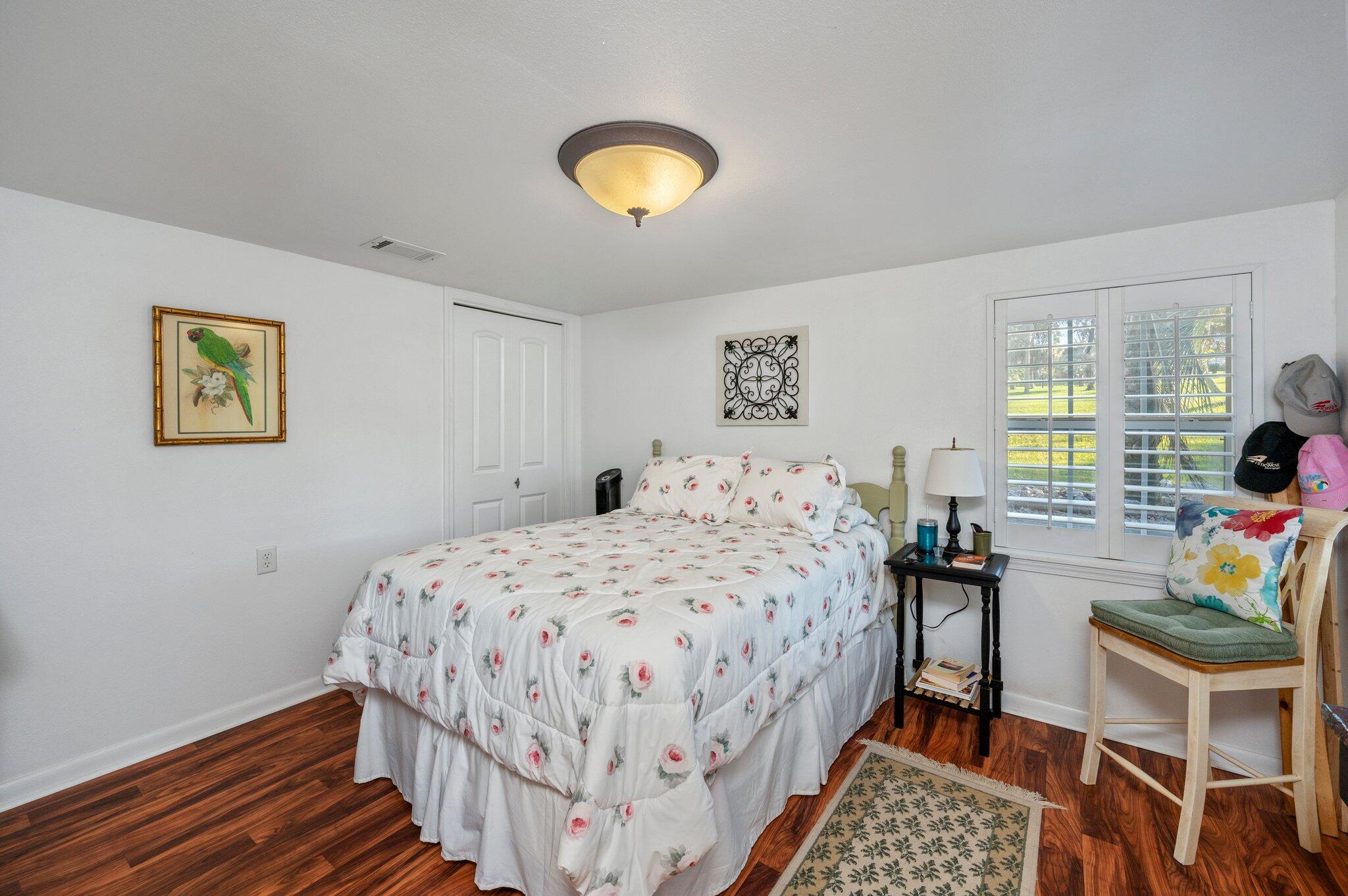 7068 Old River Road Baker, FL 32531 - Photo 24 of 42 a bedroom with a bed and a lamp next to a window