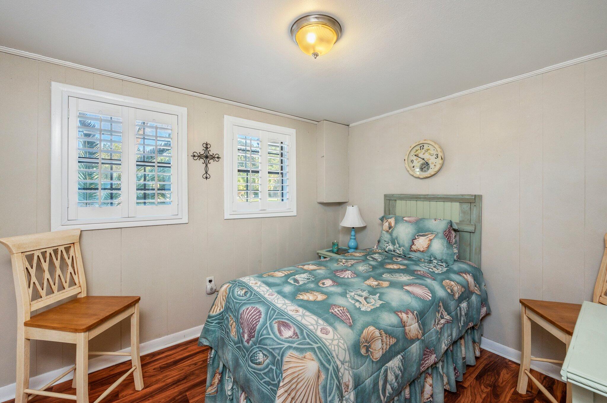 7068 Old River Road Baker, FL 32531 - Photo 25 of 42 a bedroom with a bed and a chair
