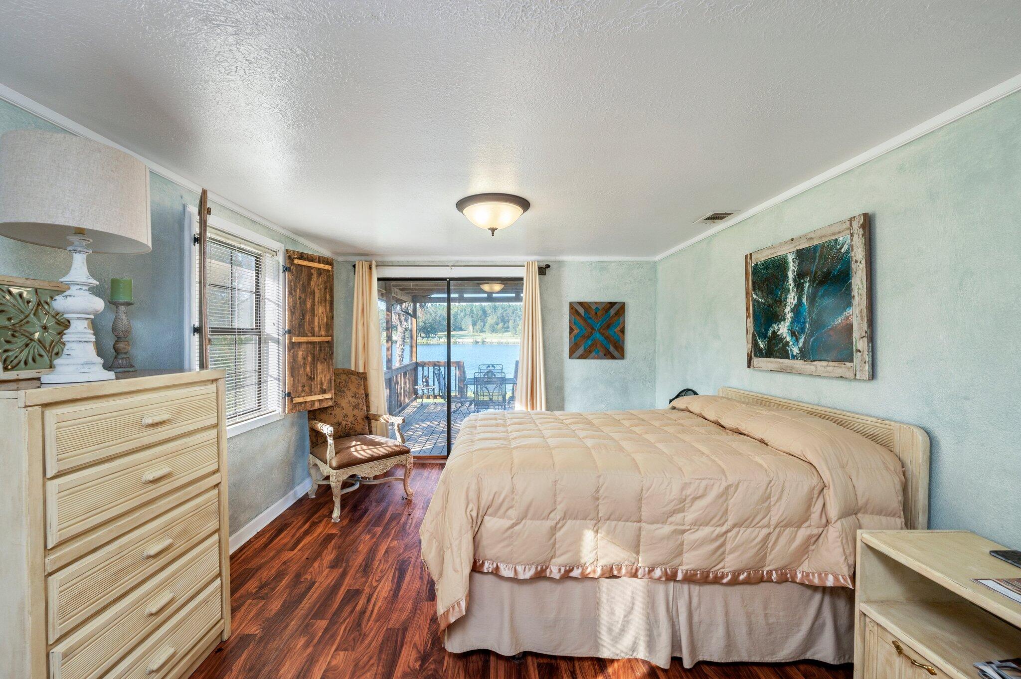 7068 Old River Road Baker, FL 32531 - Photo 27 of 42 a bedroom with a bed and large windows