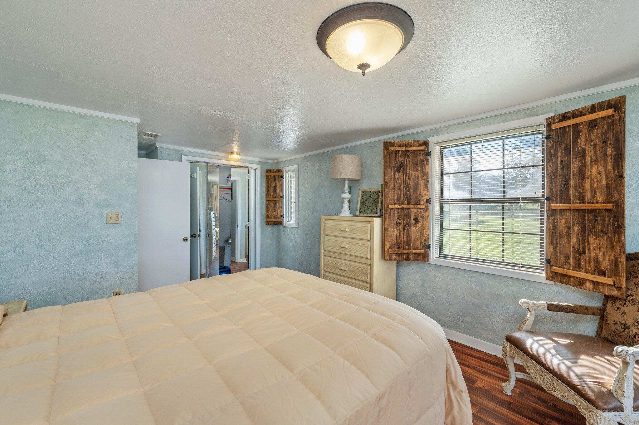 7068 Old River Road Baker, FL 32531 - Photo 28 of 42 a bedroom with a bed and a large window