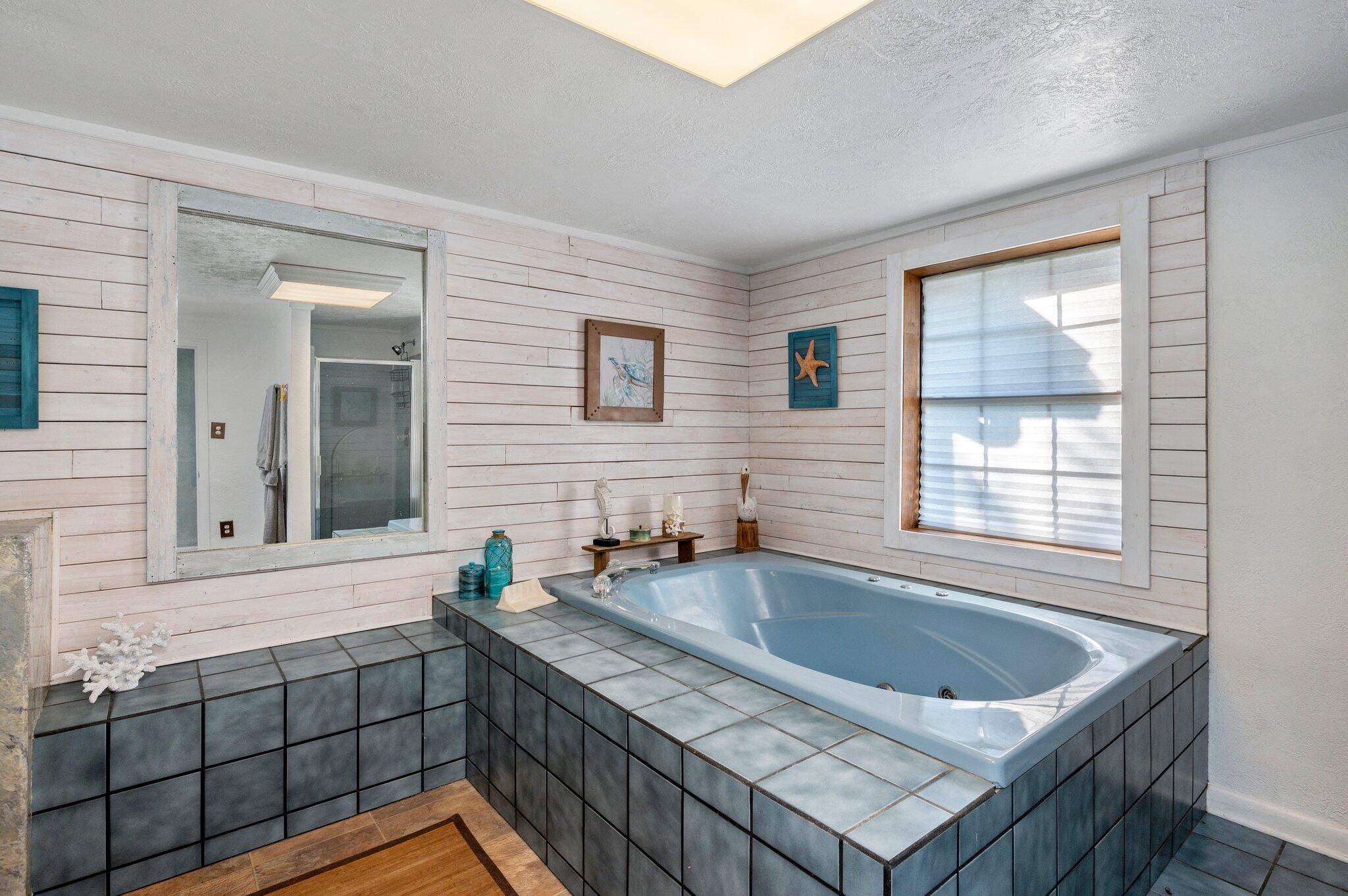 7068 Old River Road Baker, FL 32531 - Photo 29 of 42 a bathroom with a tub a sink and a window