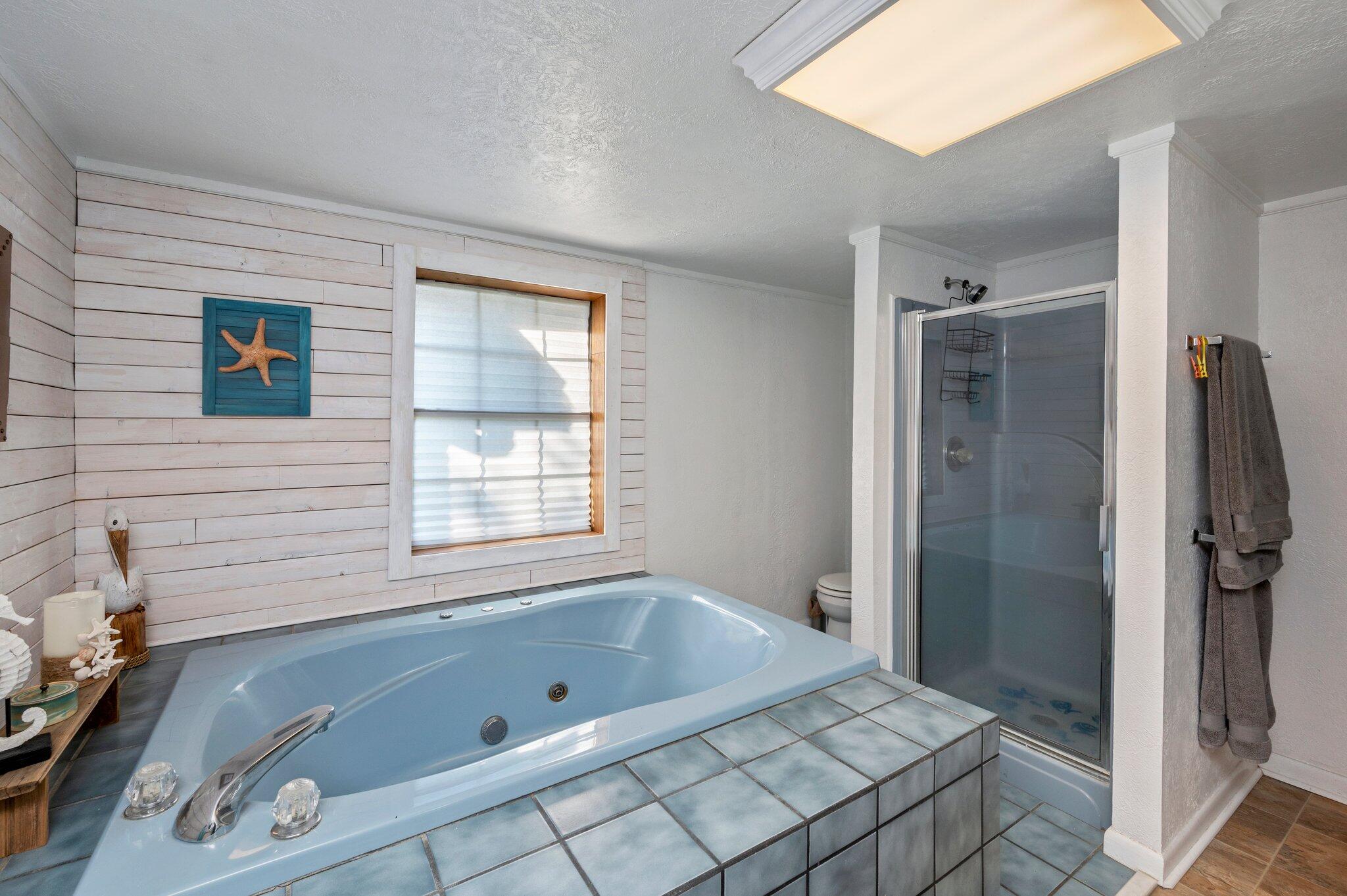 7068 Old River Road Baker, FL 32531 - Photo 31 of 42 a bathroom with a tub a sink and a shower