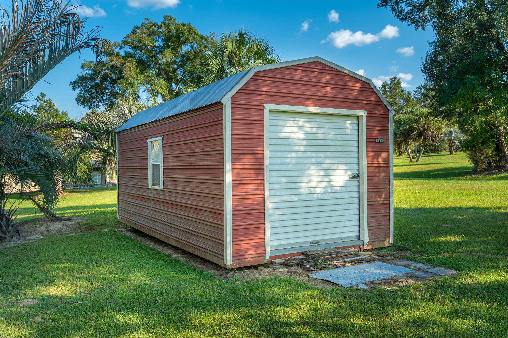 7068 Old River Road Baker, FL 32531 - Photo 40 of 42 a view of a backyard with a garden