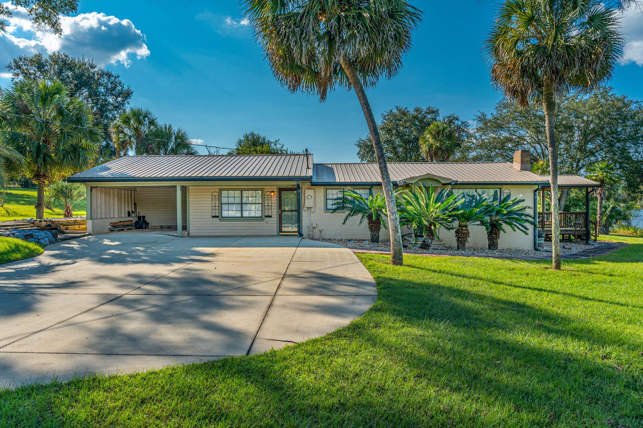 7068 Old River Road Baker, FL 32531 - Photo 10 of 42 a house with swimming pool in front of it
