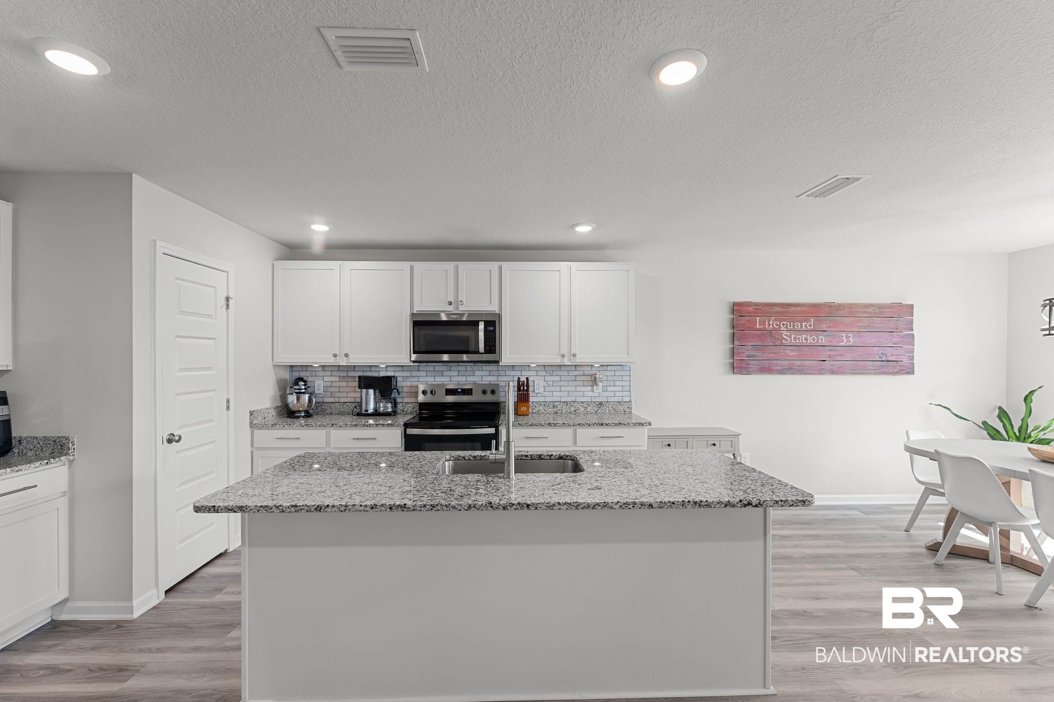 24337 Ringneck Loop Elberta, AL 36530 - Photo 12 of 34 Kitchen featuring white cabinets, light stone counters, light wood finished floors, stainless steel appliances, and recessed lighting