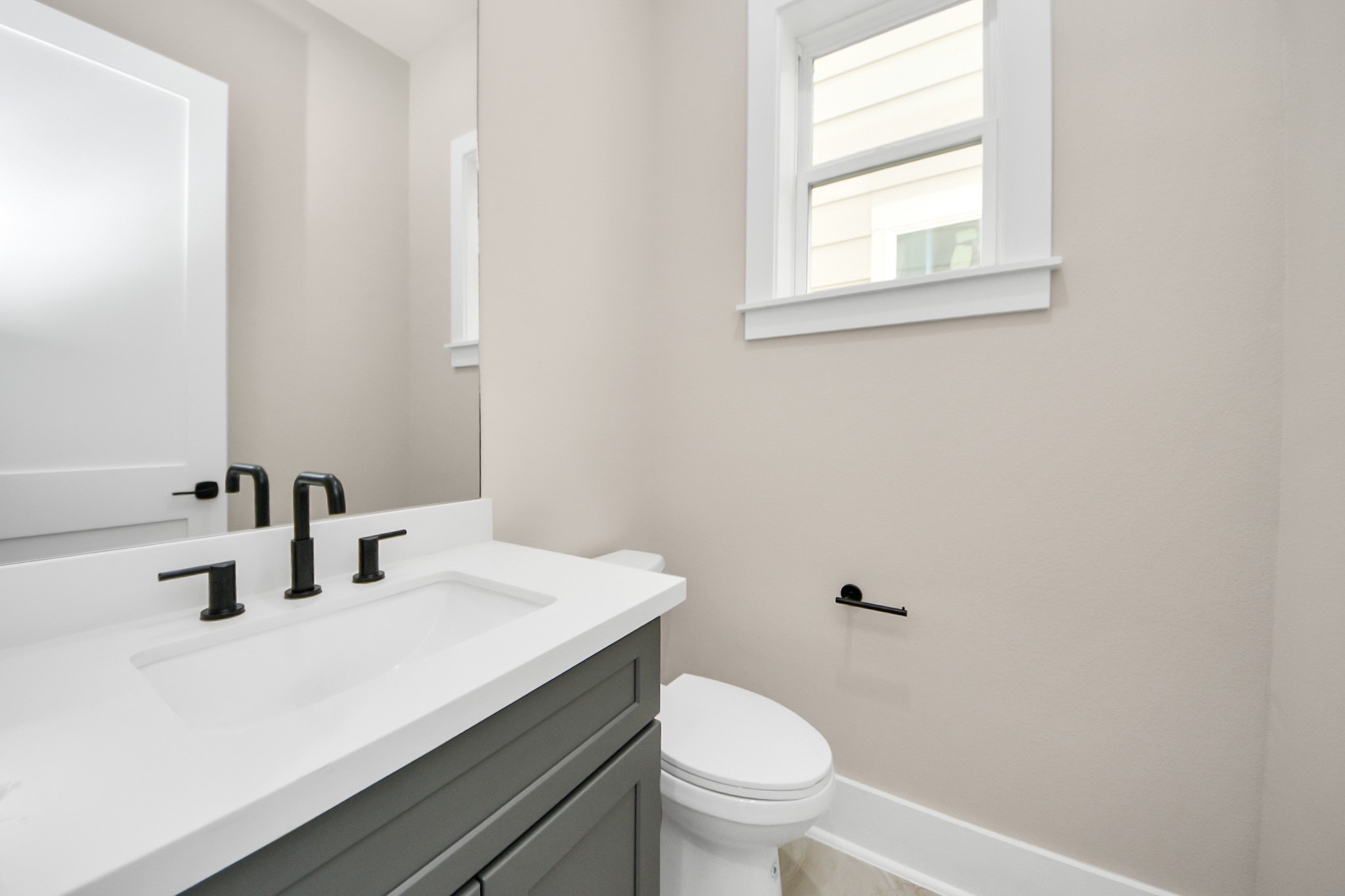 6320 Milwee Street, Unit A Houston, TX 77092 - Photo 11 of 42 a bathroom with a sink a toilet and mirror