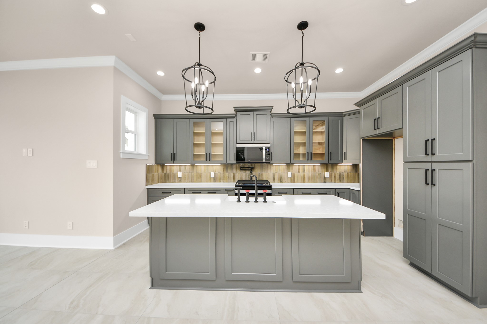 6320 Milwee Street, Unit A Houston, TX 77092 - Photo 12 of 42 a large kitchen with stainless steel appliances kitchen island a refrigerator and a chandelier