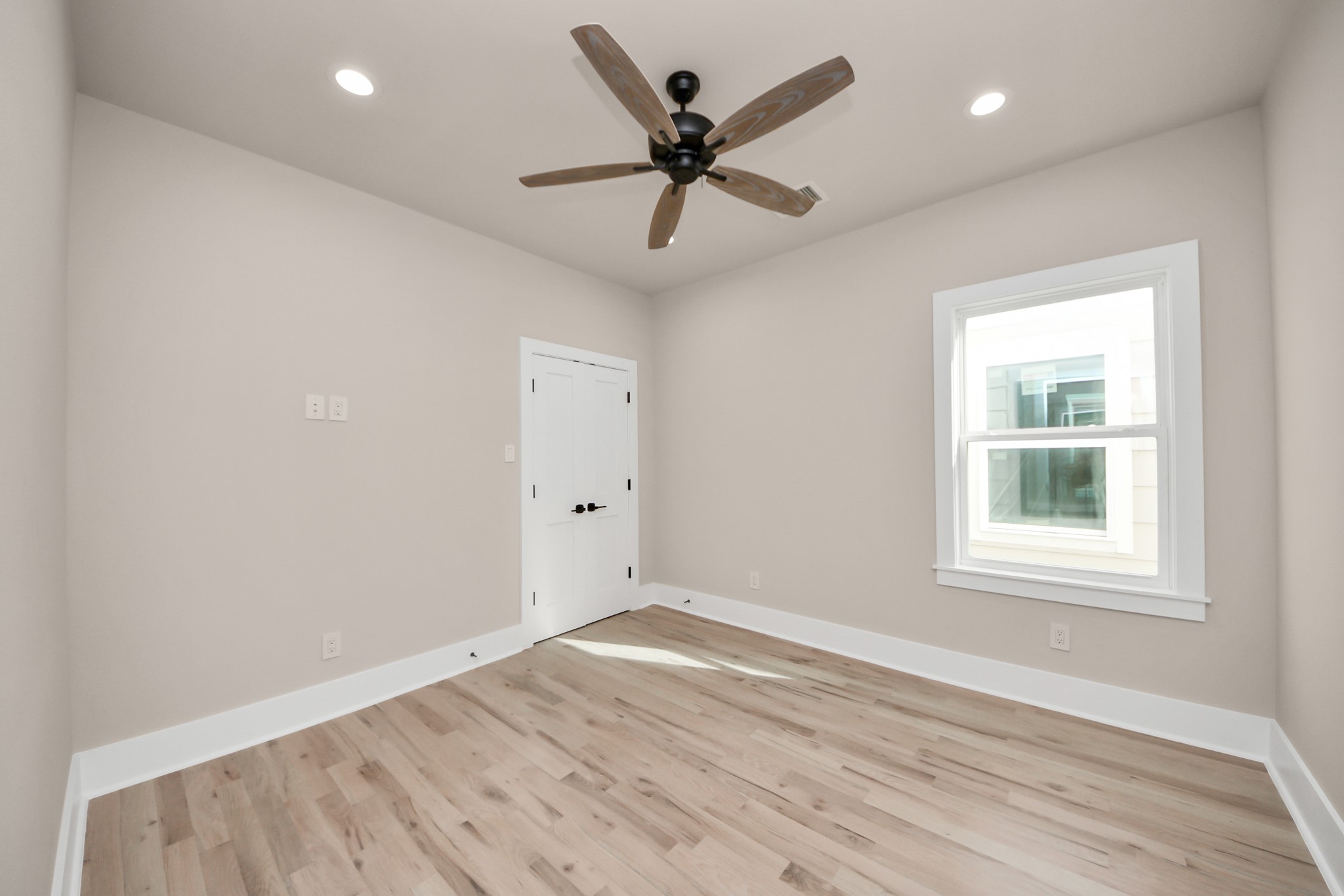 6320 Milwee Street, Unit A Houston, TX 77092 - Photo 27 of 42 an empty room with wooden floor ceiling fan and windows