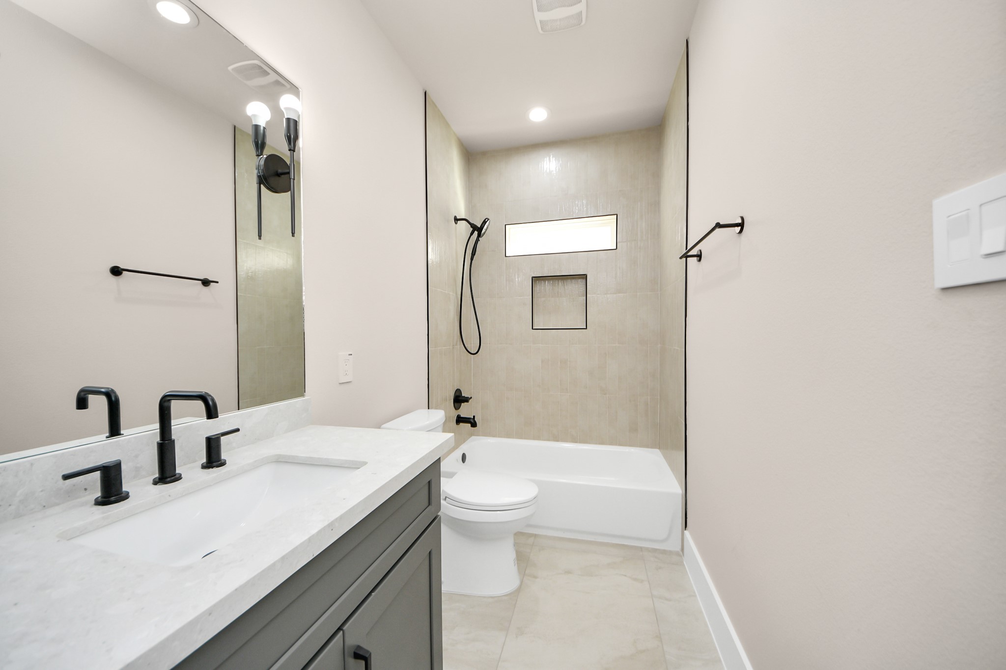 6320 Milwee Street, Unit A Houston, TX 77092 - Photo 31 of 42 a bathroom with a granite countertop sink a toilet and shower