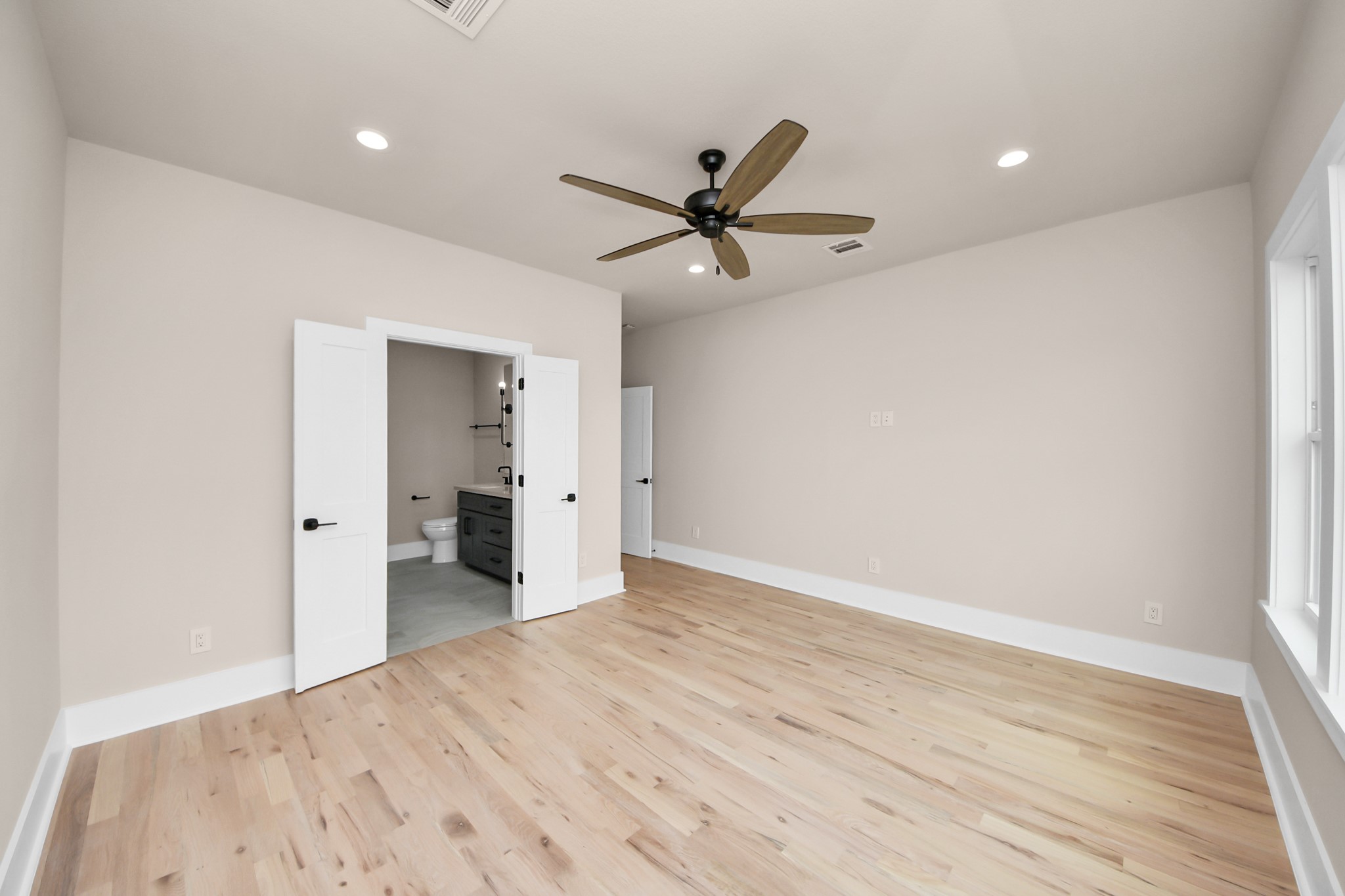 6320 Milwee Street, Unit A Houston, TX 77092 - Photo 35 of 42 a view of a big room with wooden floor and a ceiling fan