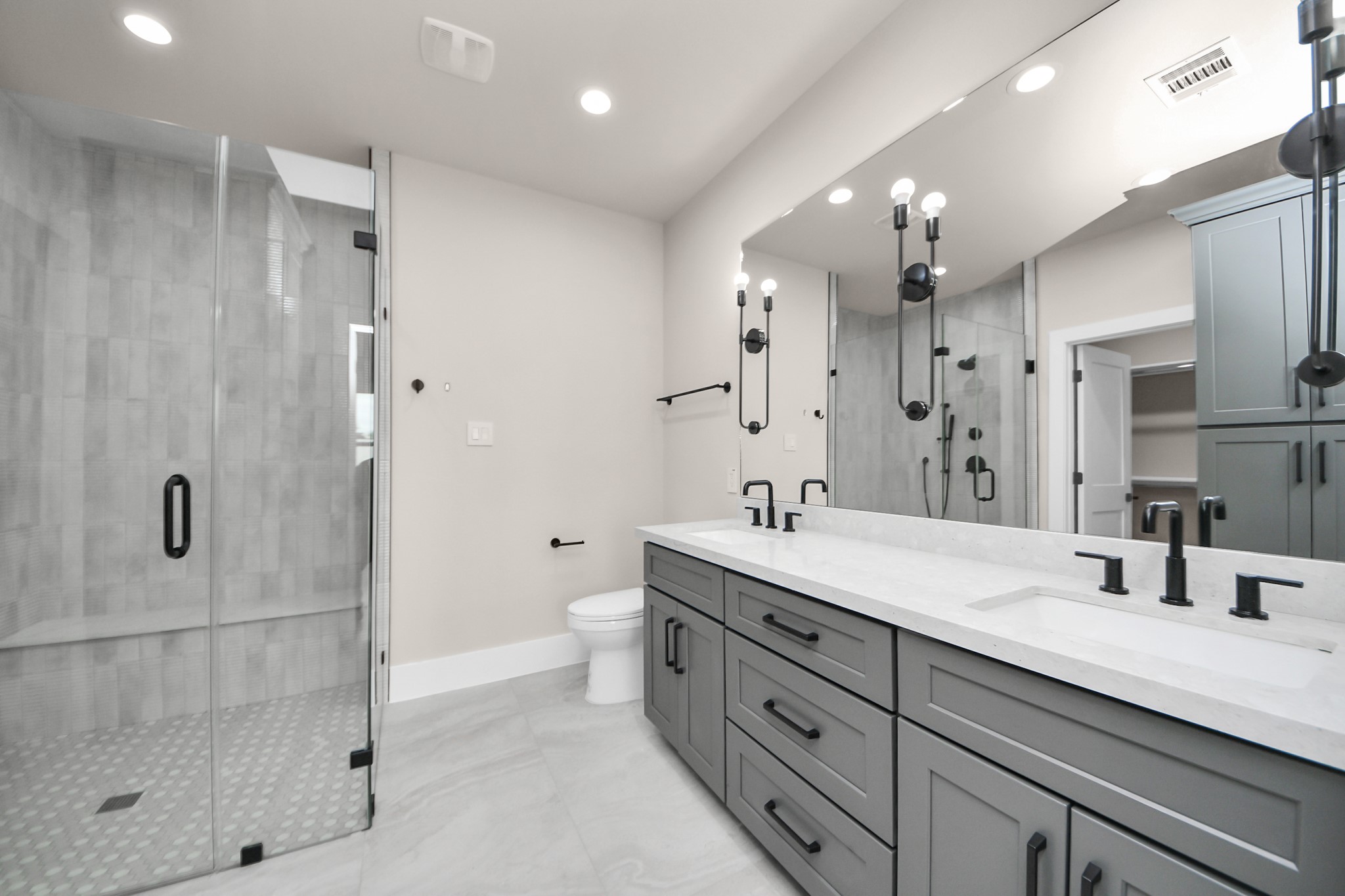 6320 Milwee Street, Unit A Houston, TX 77092 - Photo 36 of 42 a spacious bathroom with a granite countertop sink a toilet a mirror and shower