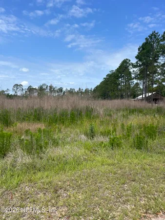 a view of lake with green space