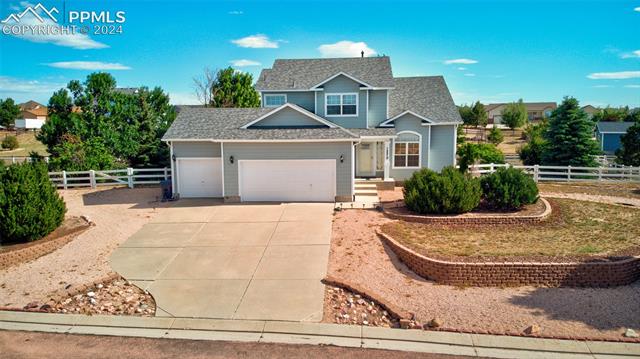 12510 Motley Road Peyton, CO 80831 - Photo 4 of 36 View of front of house featuring a garage