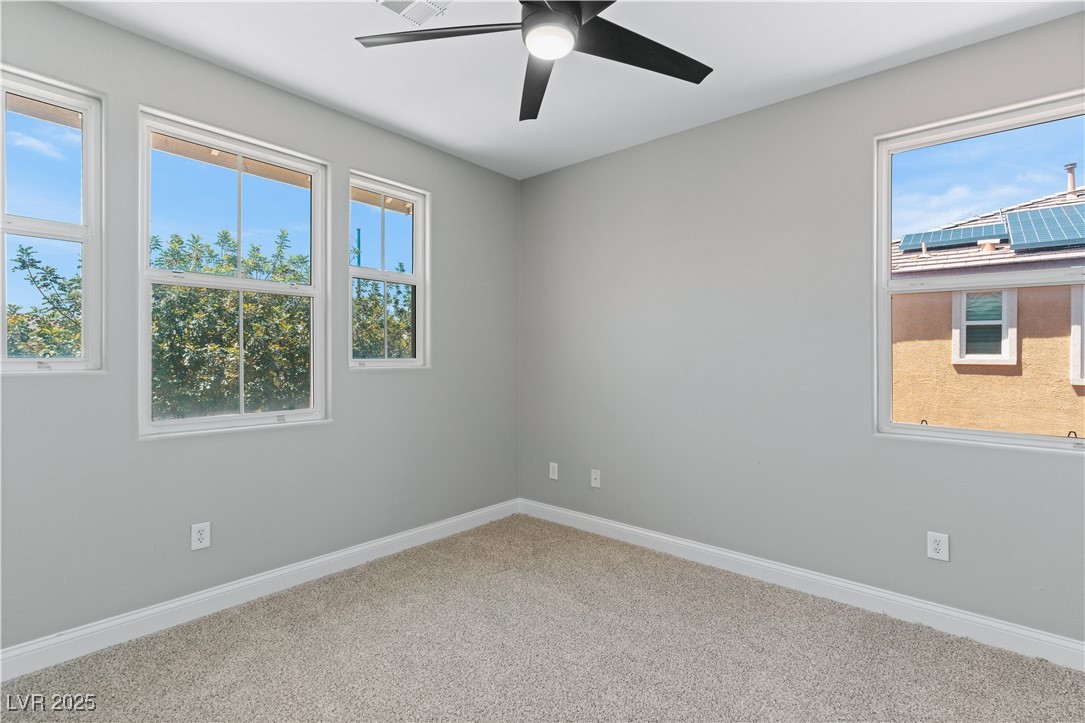 312 Pocono Ranch Avenue North Las Vegas, NV 89031 - Photo 27 of 34 Carpeted spare room with a ceiling fan and baseboards