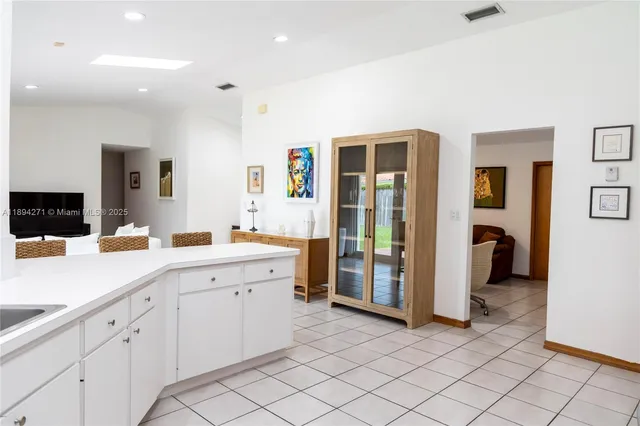 a spacious en suite bathroom with shower sinks and view