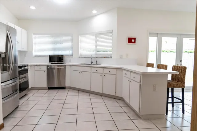 a kitchen with a sink appliances and cabinets