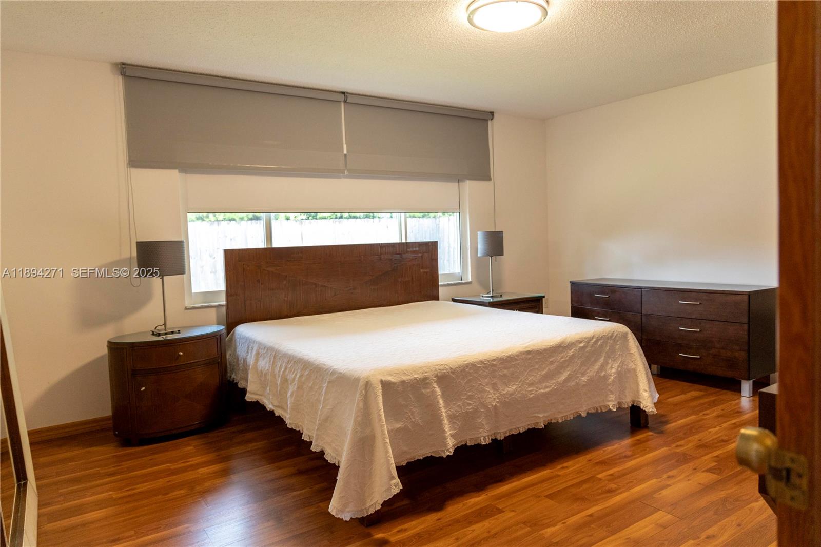 8192 Southwest 90th Avenue Miami, FL 33173 - Photo 16 of 31 a bedroom with a bed and a night stand