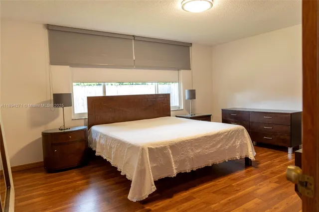 a bedroom with a bed and a night stand