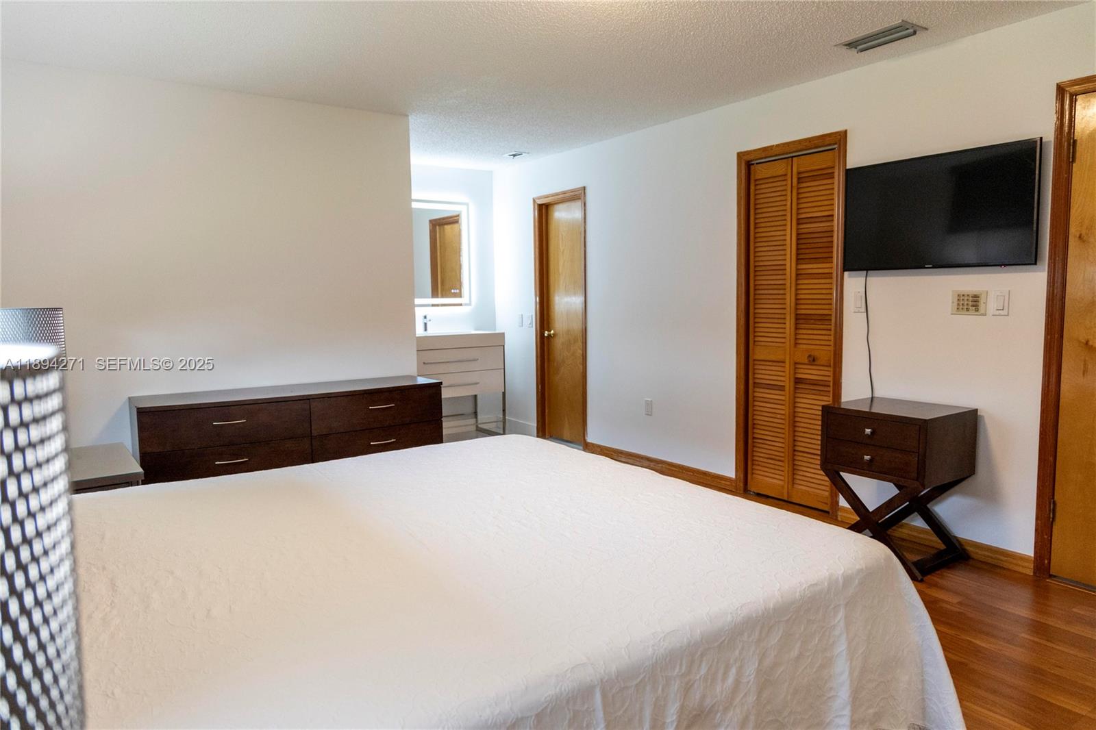 8192 Southwest 90th Avenue Miami, FL 33173 - Photo 18 of 31 a bedroom with a bed and a flat screen tv