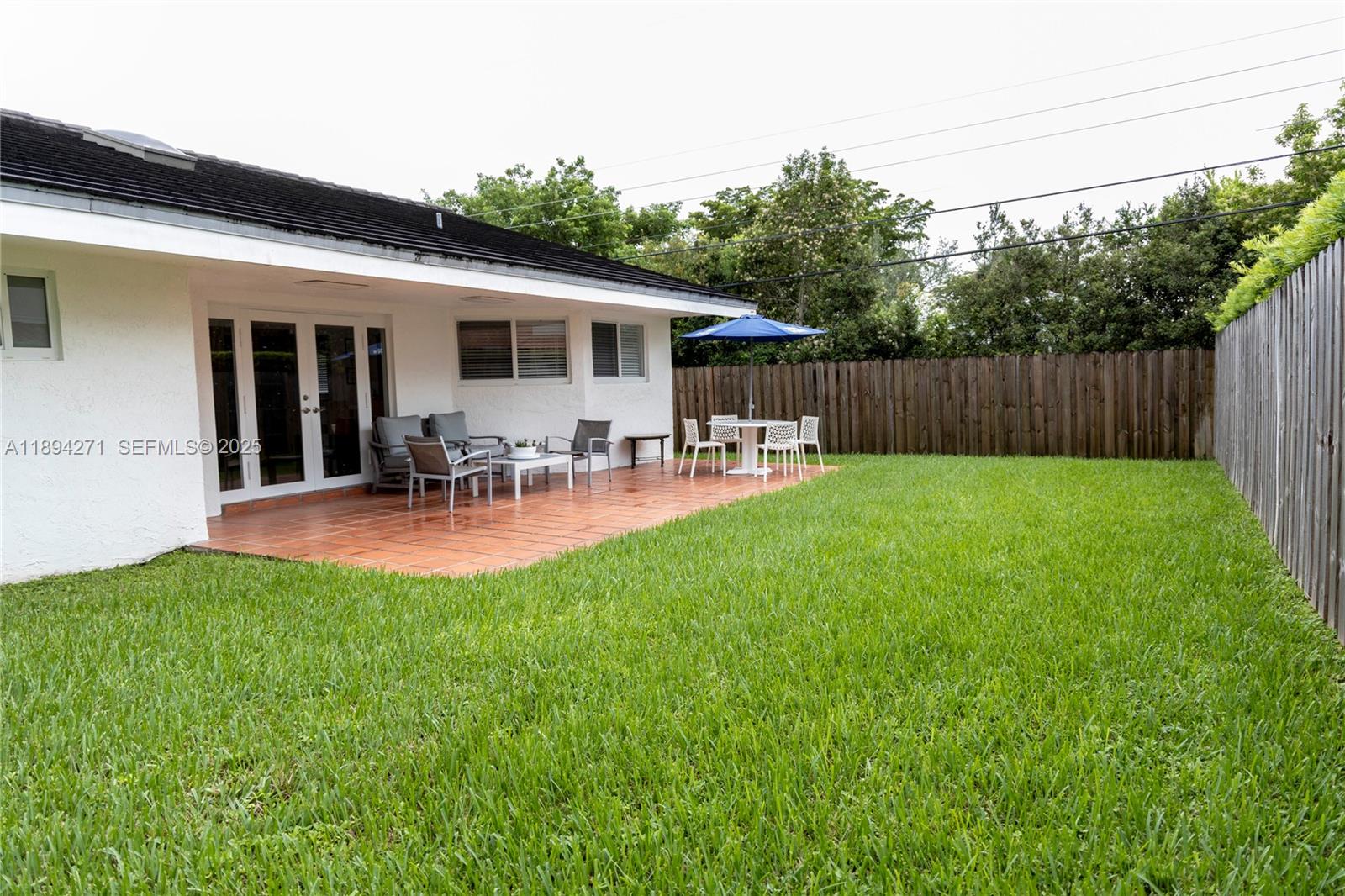 8192 Southwest 90th Avenue Miami, FL 33173 - Photo 31 of 31 a view of a back yard of the house with a patio