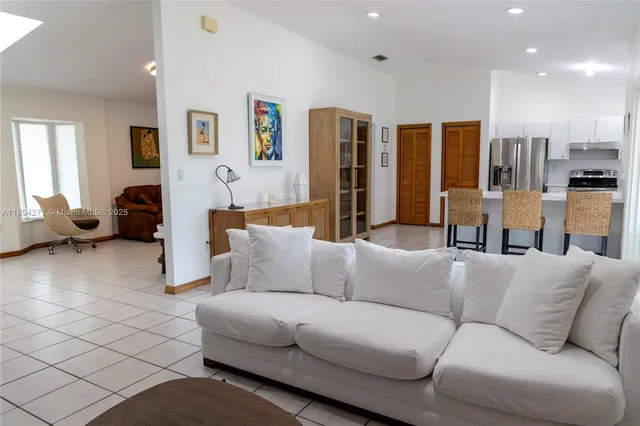 a living room with furniture and large window