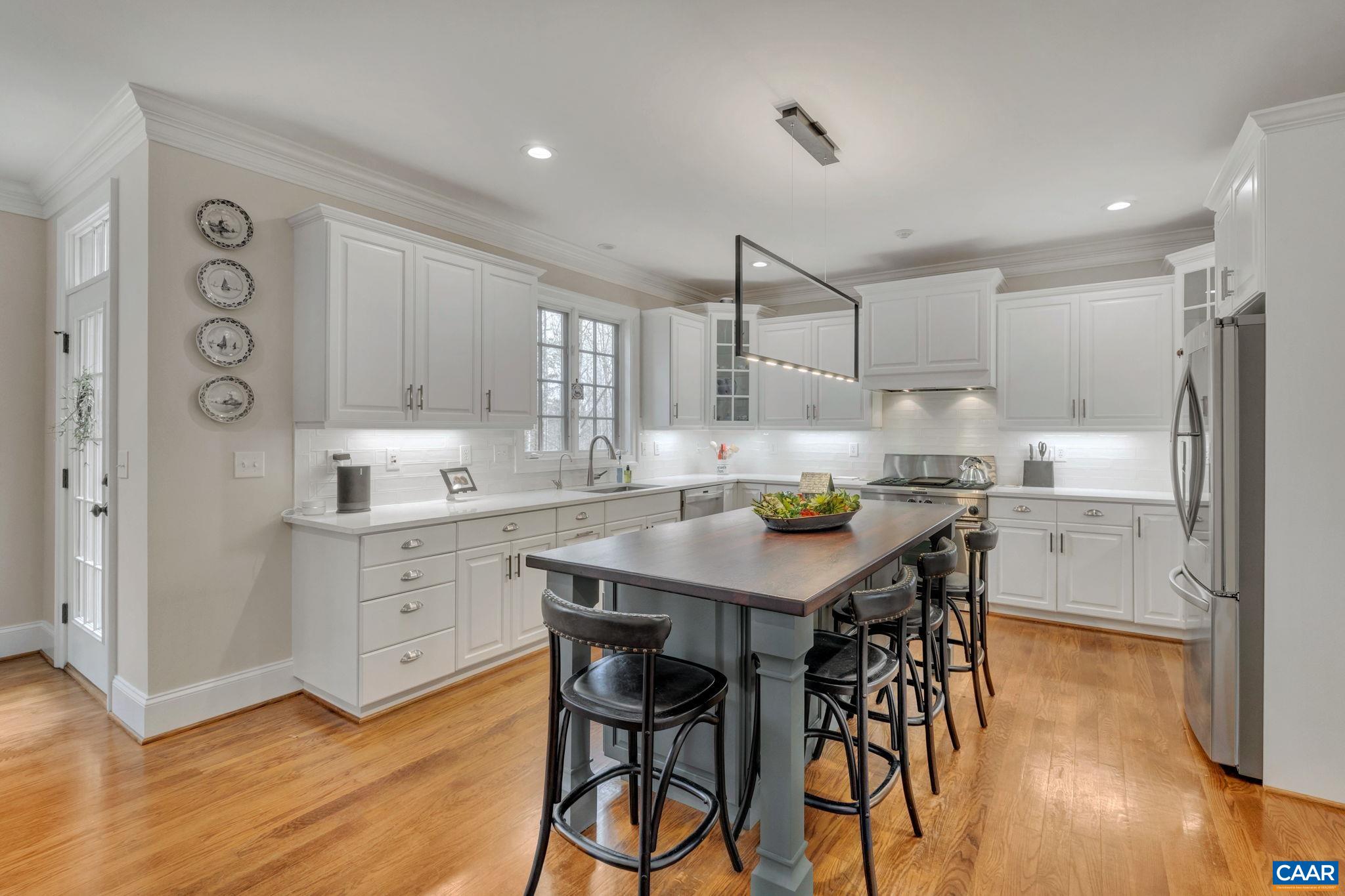 2940 Daventry Lane Charlottesville, VA 22911 - Photo 17 of 67 a kitchen with stainless steel appliances kitchen island granite countertop a table chairs sink and cabinets