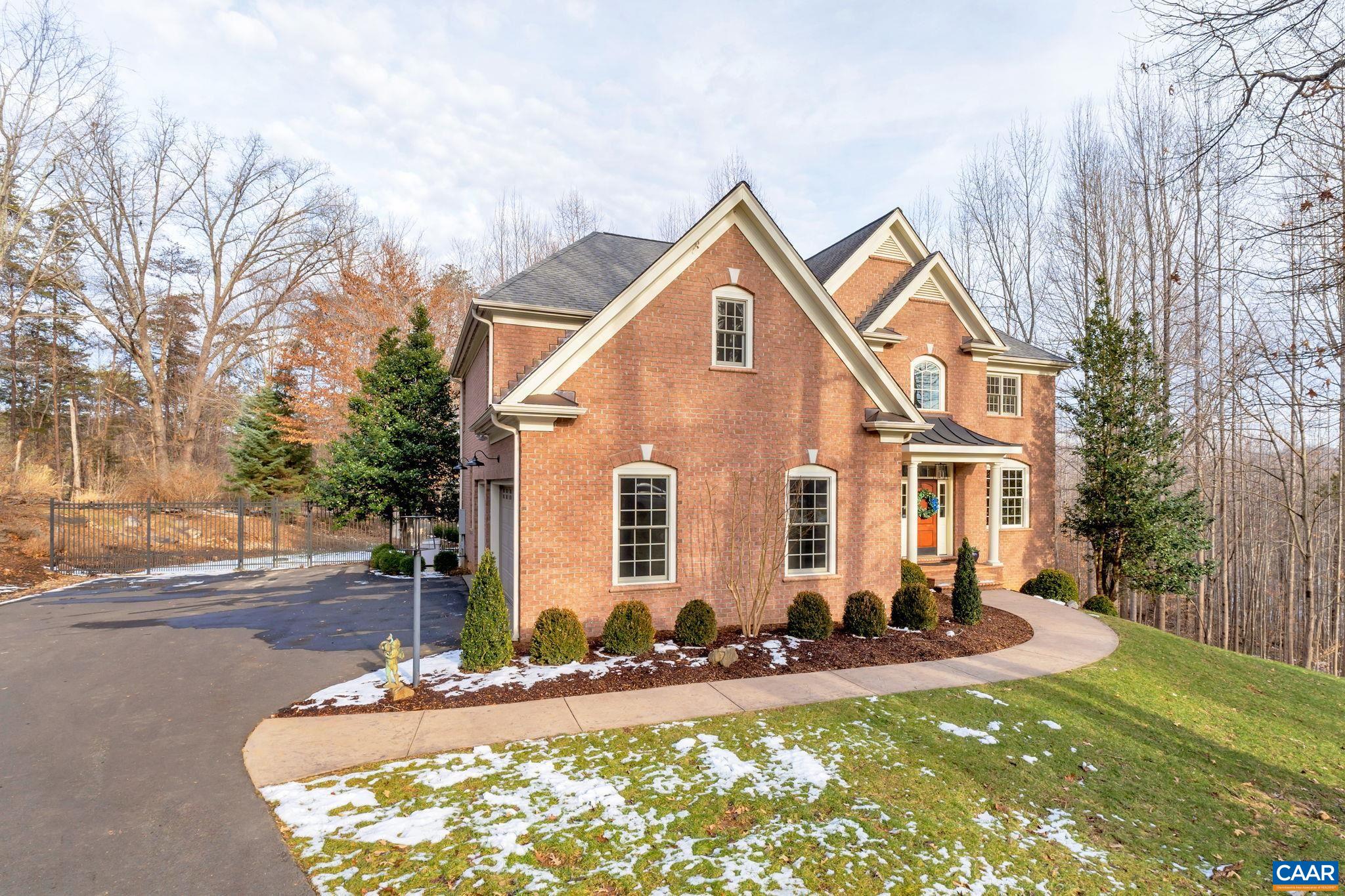 2940 Daventry Lane Charlottesville, VA 22911 - Photo 3 of 67 a view of a white house with a yard and lawn chairs under a large tree