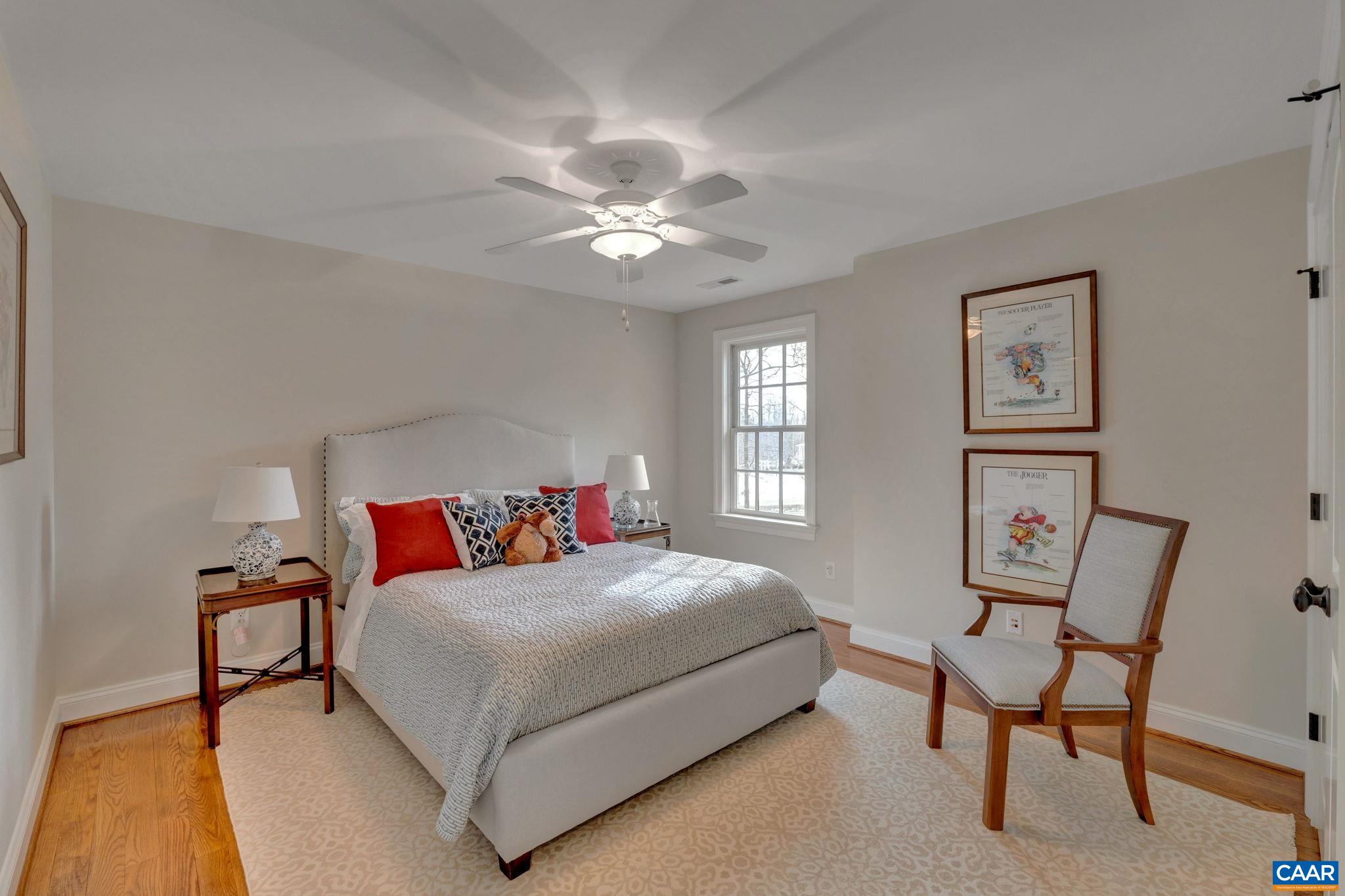 2940 Daventry Lane Charlottesville, VA 22911 - Photo 41 of 67 a bedroom with a bed and a chandelier