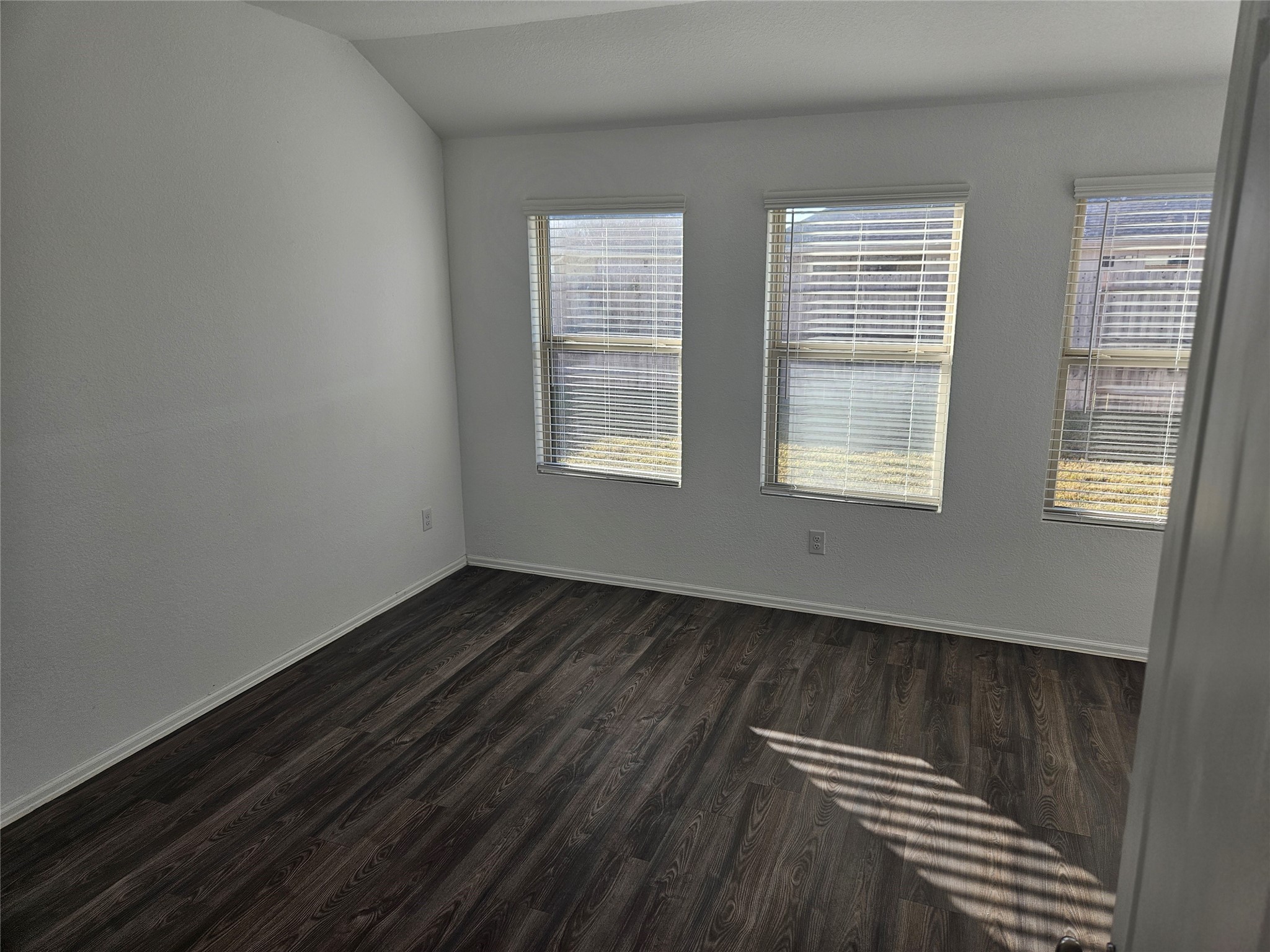 4926 Lenox Grv Lane Rosharon, TX 77583 - Photo 11 of 26 an empty room with wooden floor and windows