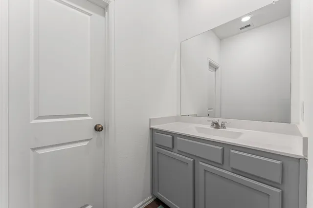 a bathroom with a sink and vanity