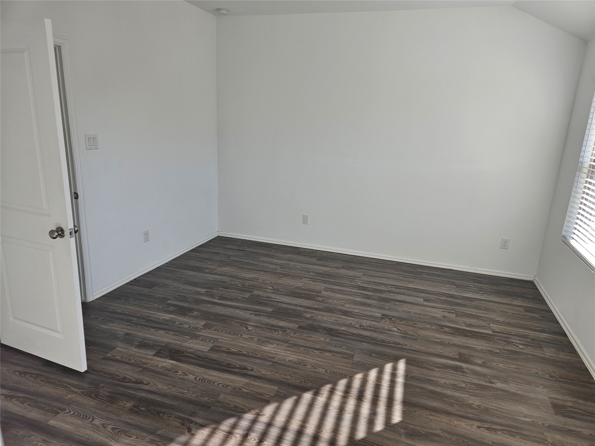 4926 Lenox Grv Lane Rosharon, TX 77583 - Photo 16 of 26 a view of an empty room with wooden floor and a window