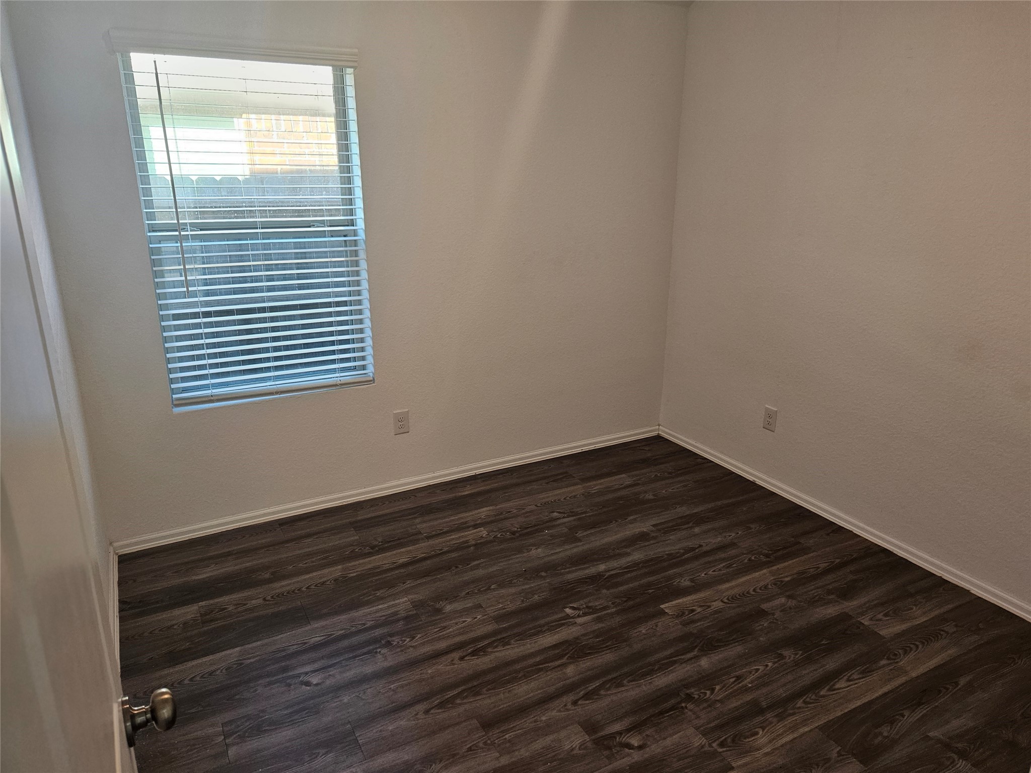 4926 Lenox Grv Lane Rosharon, TX 77583 - Photo 21 of 26 a view of an empty room with wooden floor and a window