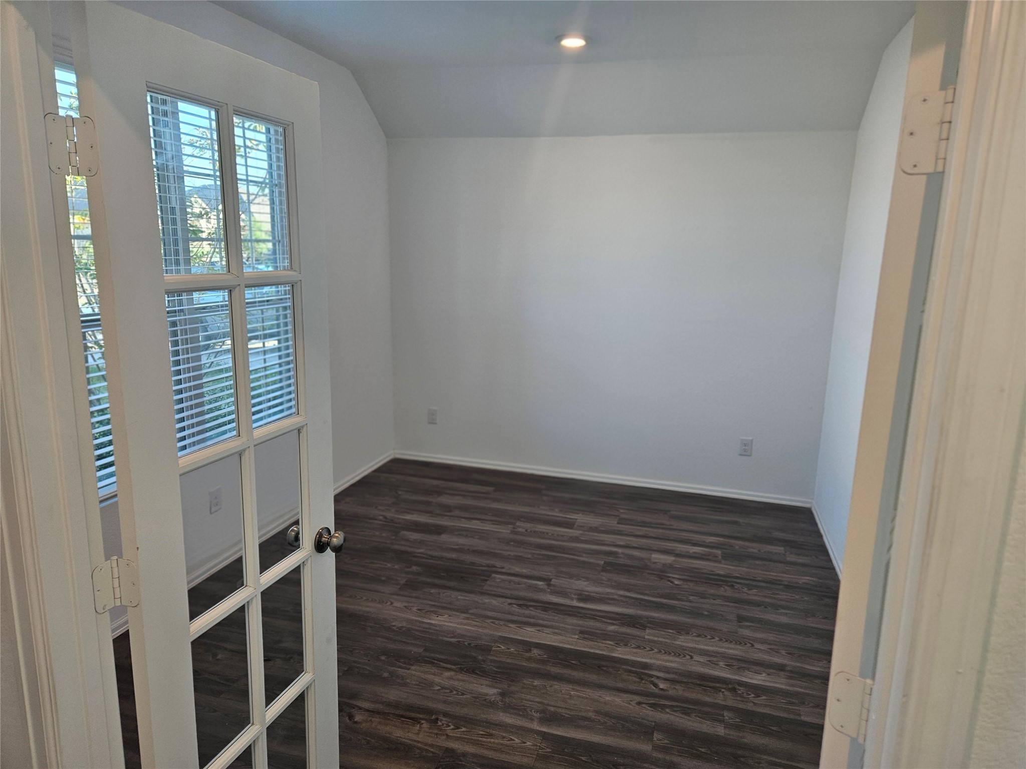 4926 Lenox Grv Lane Rosharon, TX 77583 - Photo 5 of 26 a view of an empty room with wooden floor and a window
