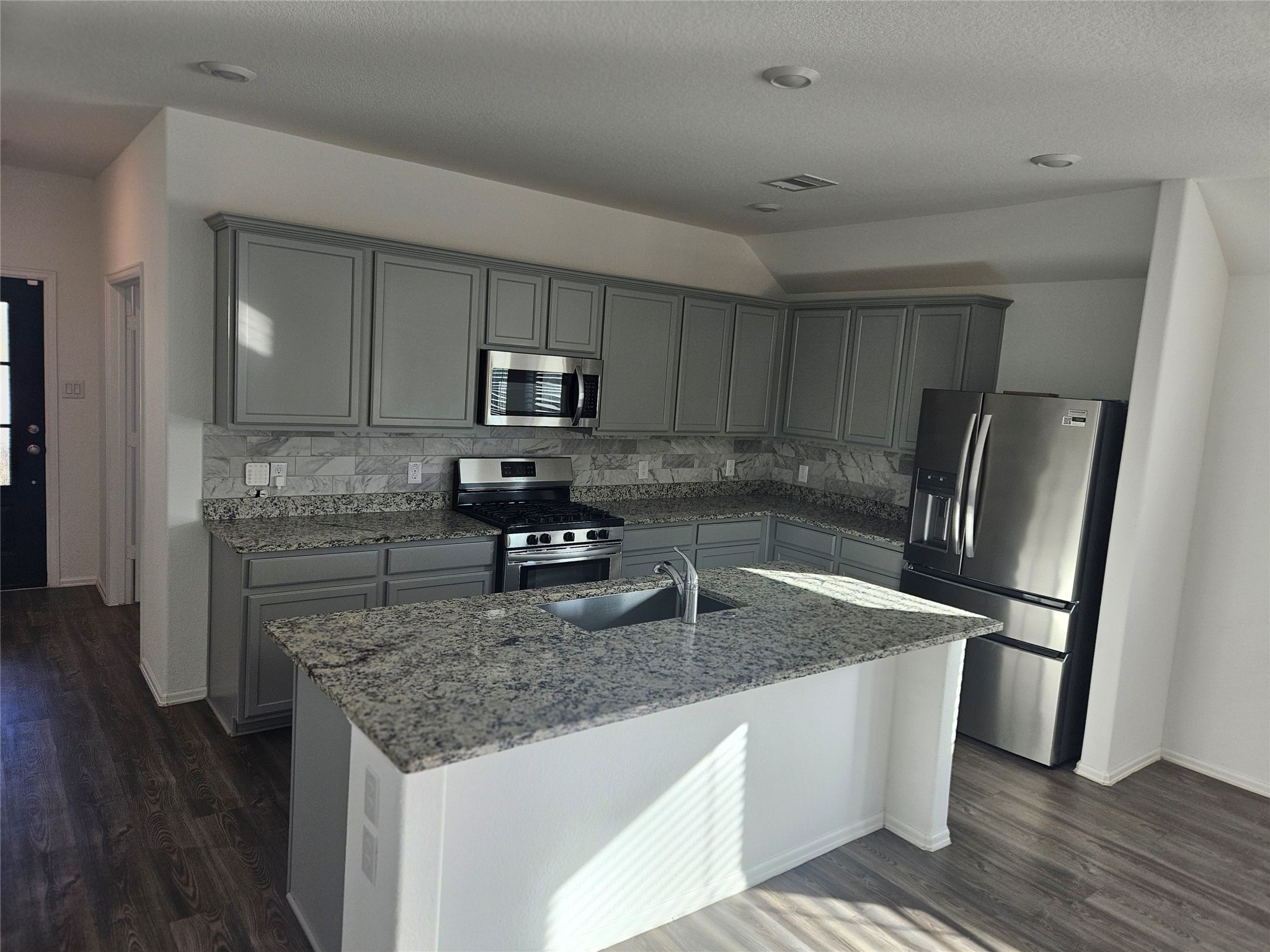 4926 Lenox Grv Lane Rosharon, TX 77583 - Photo 7 of 26 a kitchen with kitchen island granite countertop a sink stove and refrigerator