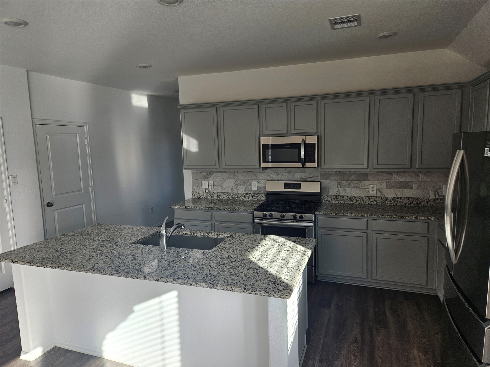 4926 Lenox Grv Lane Rosharon, TX 77583 - Photo 10 of 26 a kitchen with stainless steel appliances granite countertop a sink stove and refrigerator