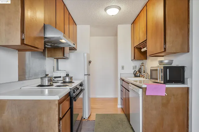a kitchen filled with a white cabinets and chairs