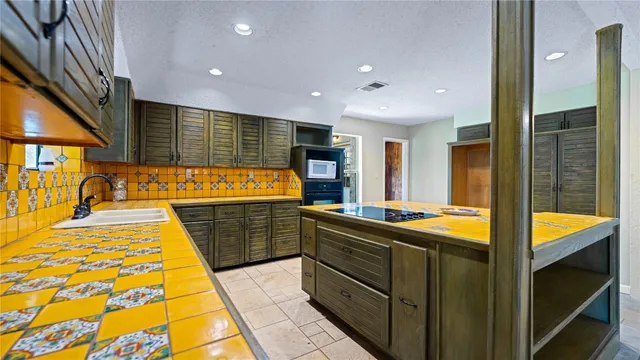 a kitchen with stainless steel appliances granite countertop sink and cabinets
