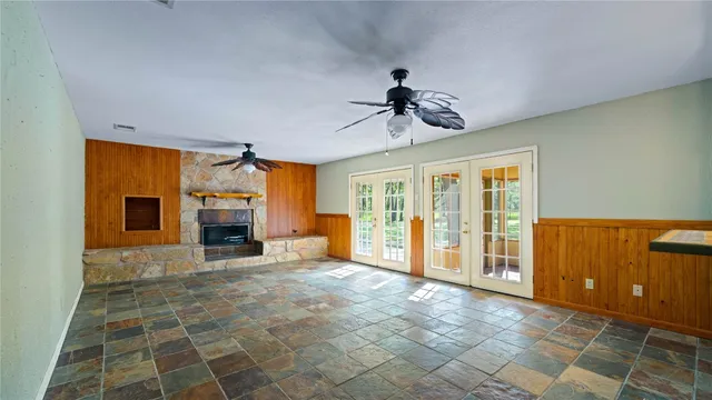 a view of an empty room with a fireplace and a window