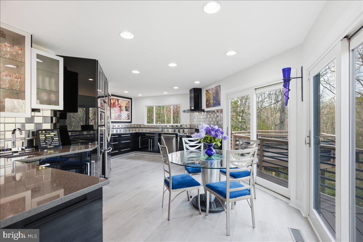 1142 Ranger Ridge Road Lusby, MD 20657 - Photo 11 of 53 a dining room with furniture and a floor to ceiling window