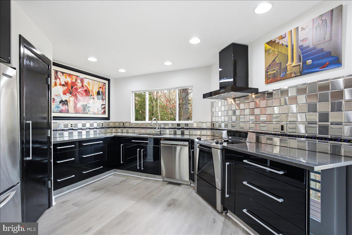 1142 Ranger Ridge Road Lusby, MD 20657 - Photo 16 of 53 a kitchen with stainless steel appliances granite countertop a stove and a sink