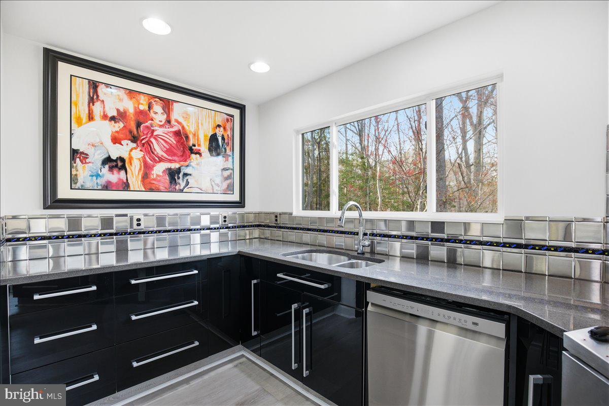 1142 Ranger Ridge Road Lusby, MD 20657 - Photo 18 of 53 a kitchen with a sink stove and cabinets