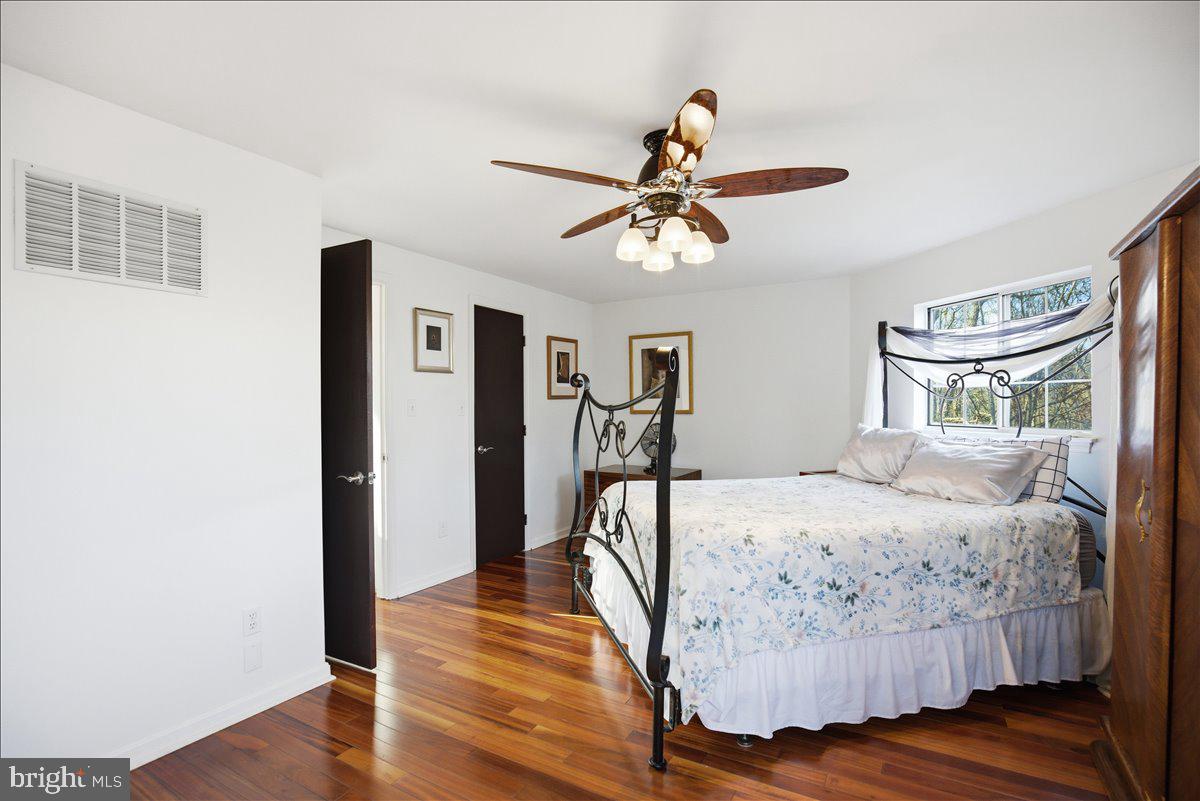 1142 Ranger Ridge Road Lusby, MD 20657 - Photo 23 of 53 a bedroom with a bed and wooden floor