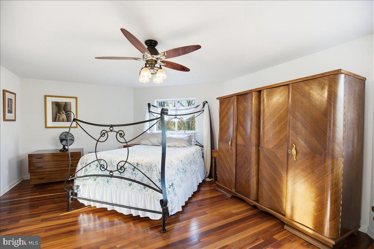 1142 Ranger Ridge Road Lusby, MD 20657 - Photo 24 of 53 a bedroom with a bed and wooden floor
