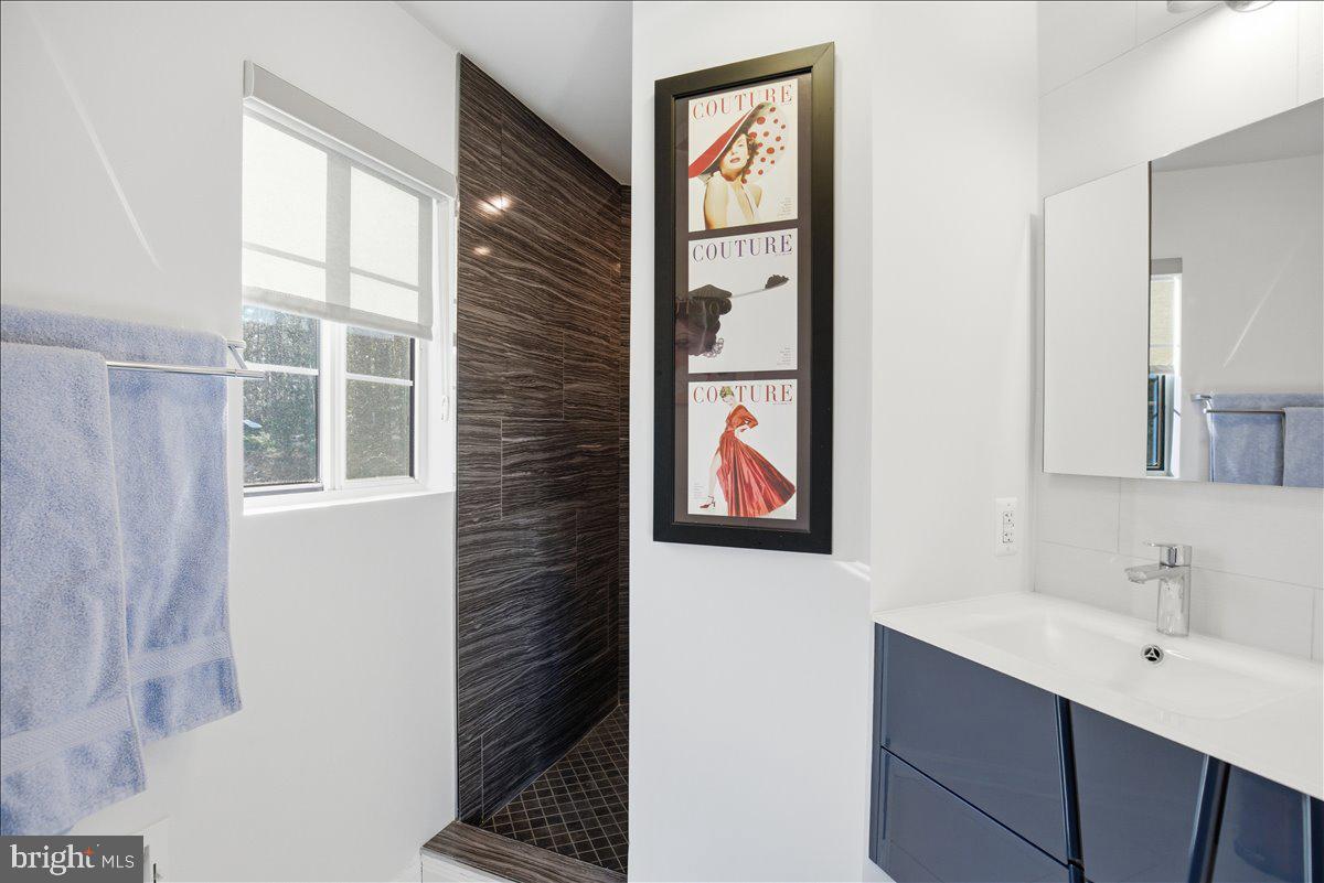 1142 Ranger Ridge Road Lusby, MD 20657 - Photo 26 of 53 a bathroom with a sink and a mirror