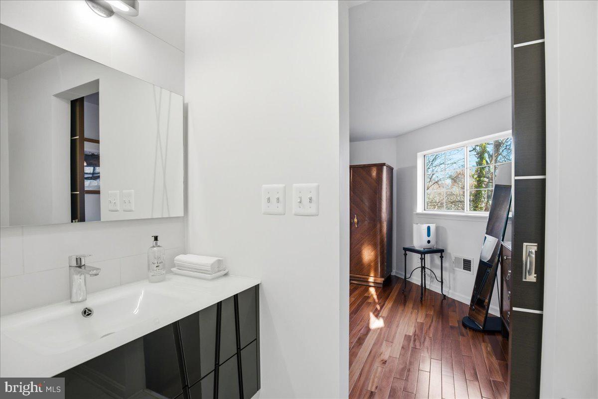 1142 Ranger Ridge Road Lusby, MD 20657 - Photo 28 of 53 a en suite bathroom with a sink mirror and a toilet