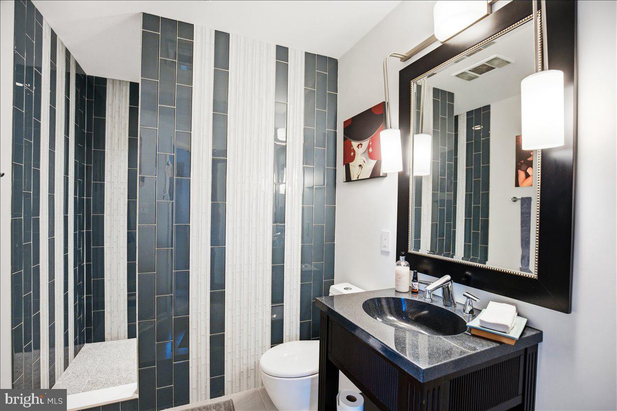 1142 Ranger Ridge Road Lusby, MD 20657 - Photo 33 of 53 a bathroom with a sink and a mirror with toilet