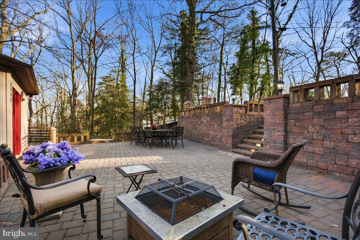 1142 Ranger Ridge Road Lusby, MD 20657 - Photo 5 of 53 a backyard of a house with table and chairs
